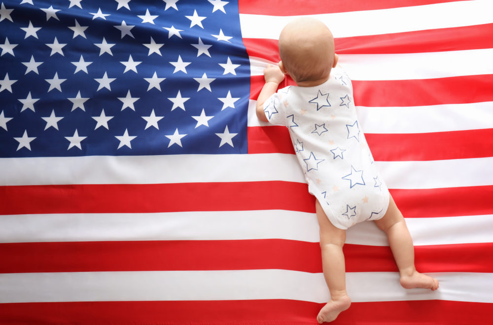 Cute baby on American flag background Cute baby on American flag background