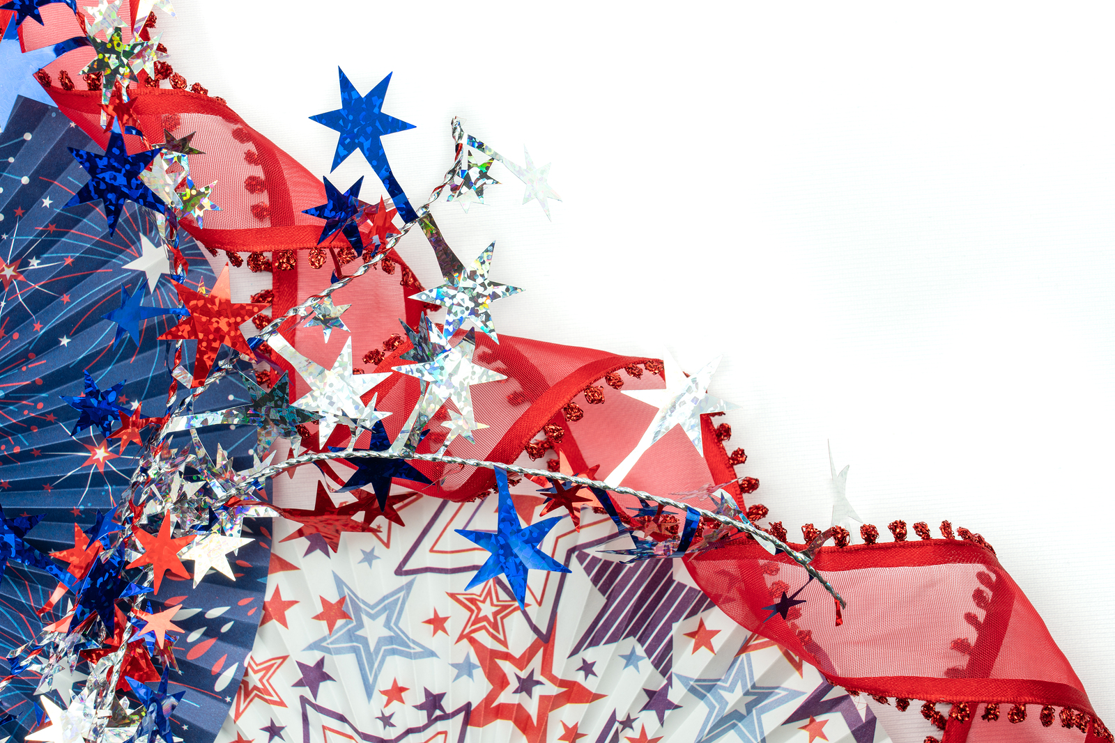 patriotic red white and blue corner border of pleated fans and red curled ribbon with a sparkly star garland