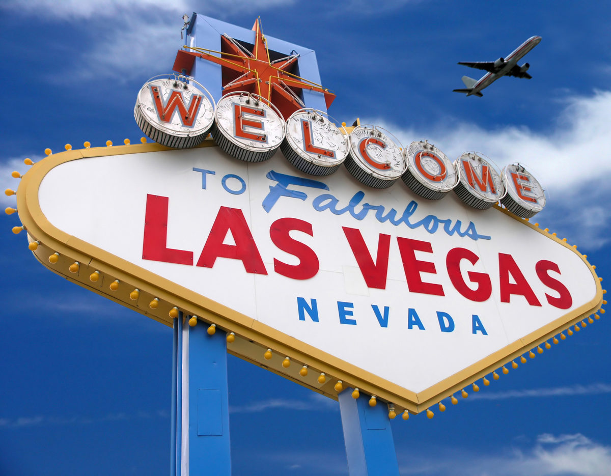 welcome to las vegas sign with plane flying overhead in las vegas *** Note, slight graininess, best at small sizes.