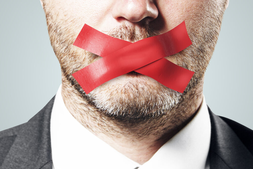 Close up of taped european businessman mouth. Silence and speech censorship concept